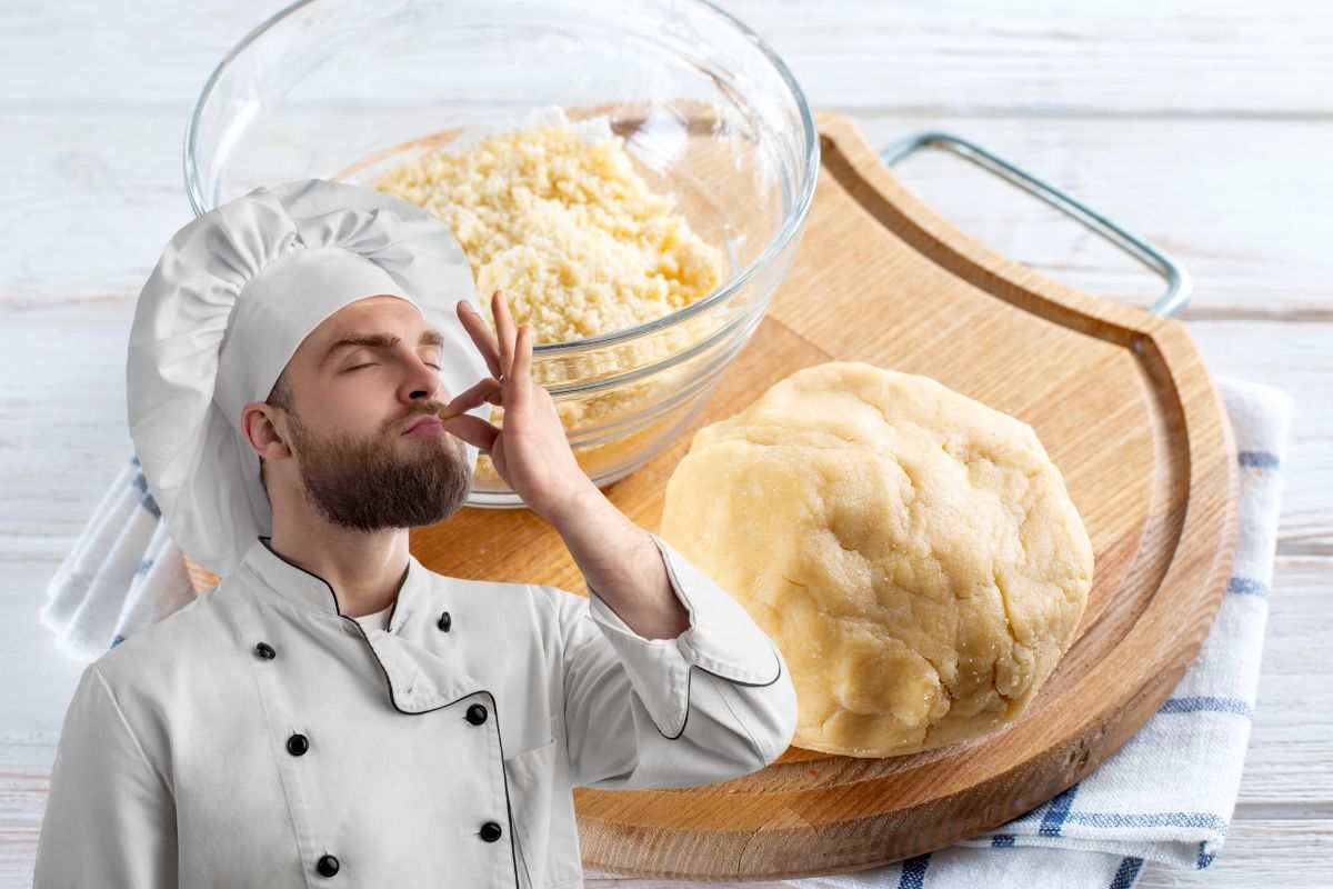 chef e pasta frolla su un tagliere in legno
